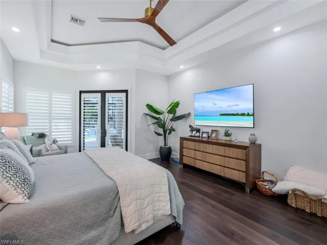 Bedroom with recessed lighting, wood finished floors, and access to exterior