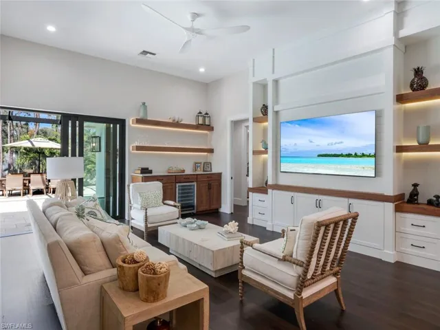 Living area featuring dark wood-style floors, recessed lighting, visible vents, and ceiling fan