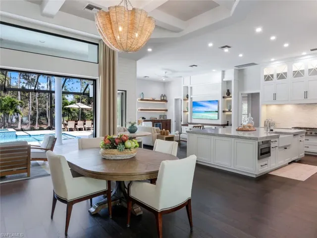 Dining room featuring dark wood-style floors, beam ceiling, visible vents, and recessed lighting