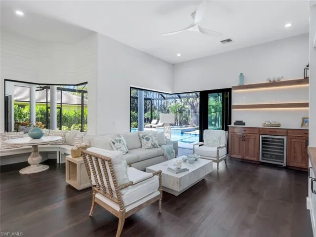 Living area featuring dark wood-style floors, wine cooler, visible vents, and recessed lighting