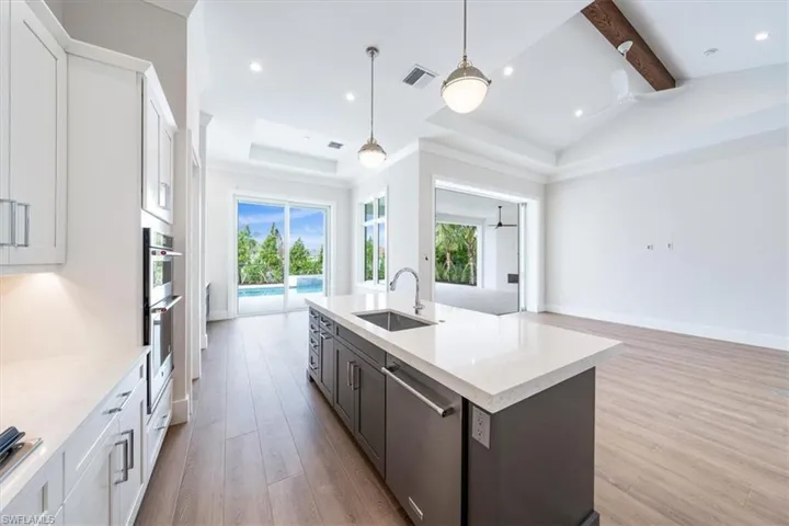 The kitchen features a walk-in pantry andKitchenAid appliance suite with 30" frenchdoor refrigerator, natural gas cooktop, combowall/microwave oven, and SS dishwasher inthe island.