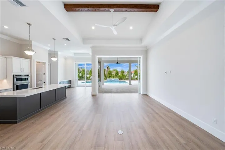 Open the front door to see straight out to thepool through 3-panel full pocket 10' impactPGT sliders from the great room.