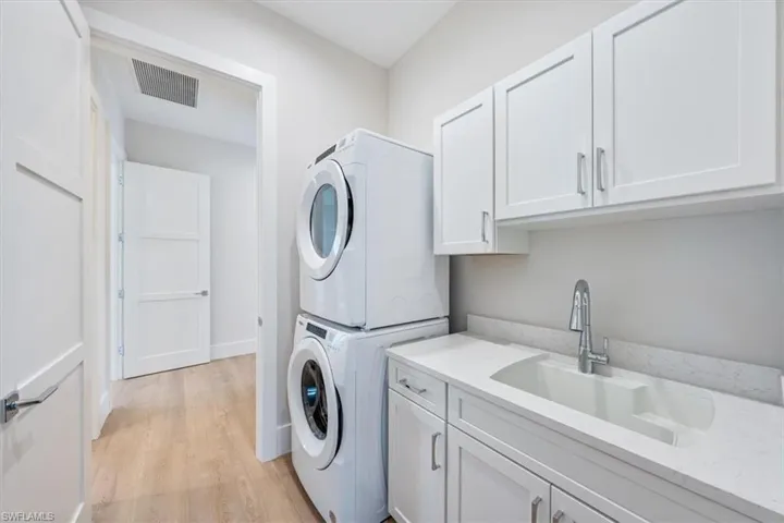 The laundry room is just off of the garage andfeatures a full-size Whirlpool stackable W/Dand laundry sink. A mudroom bench is justoutside, offering a spot to drop the day's bagsand exhale:)
