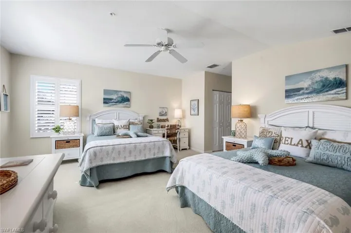 Carpeted bedroom featuring a closet, a ceiling fan, and vaulted ceiling