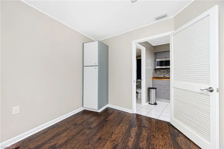 Unfurnished bedroom with hardwood / wood-style flooring