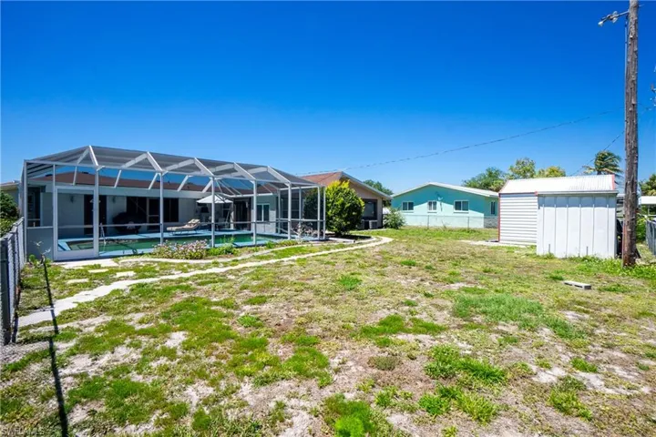 View of yard featuring a shed and a lanai
