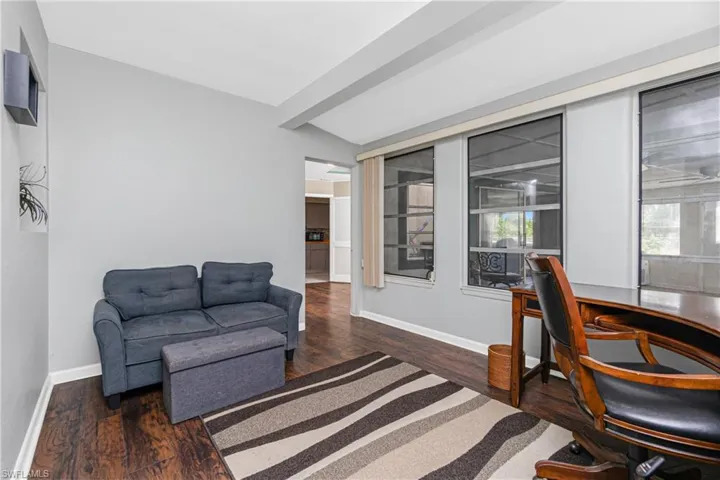 Office area featuring vaulted ceiling with beams and dark wood-type flooring