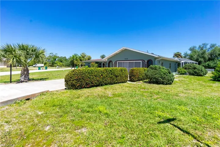 View of side of property with a lawn