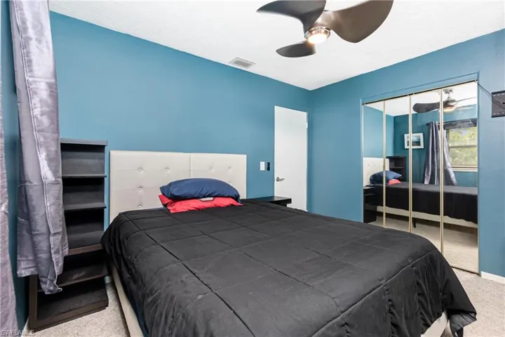 Bedroom with ceiling fan, a closet, and carpet