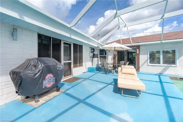 View of pool featuring a grill and a lanai