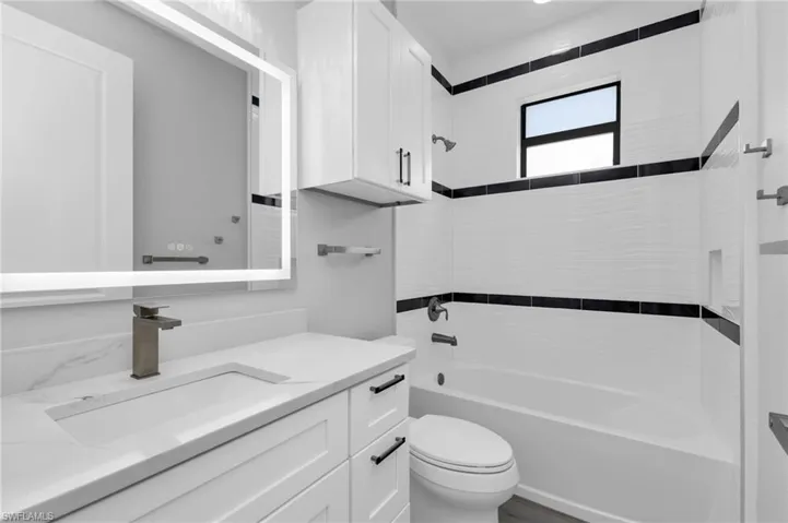 Bathroom featuring  shower combination and vanity