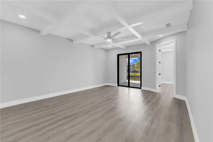 Unfurnished room featuring coffered ceiling, beam ceiling, light wood finished floors, ceiling fan, and recessed lighting