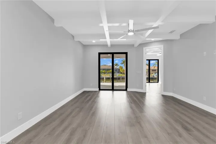 Unfurnished room with beam ceiling, light wood finished floors, a ceiling fan, and recessed lighting