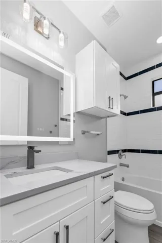 Bathroom with vanity and bathtub / shower combination