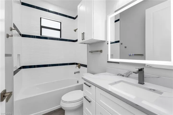 Bathroom featuring  shower combination and vanity
