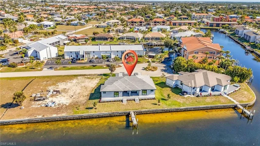 Aerial view of residential area featuring a nearby body of water
