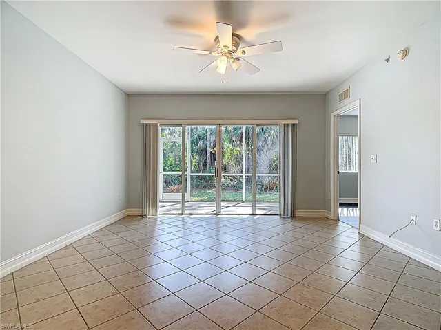 Spare room with light tile patterned floors, baseboards, visible vents, and ceiling fan