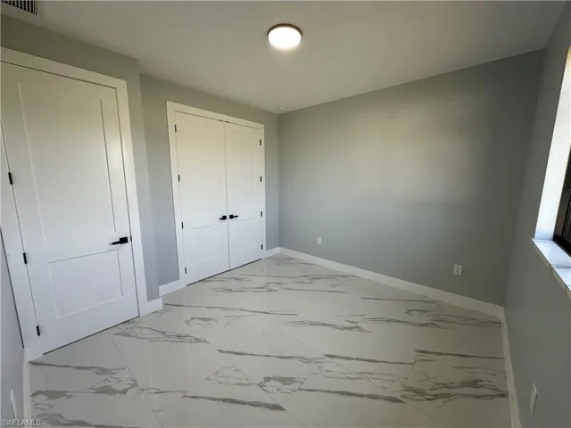 Unfurnished bedroom featuring light tile patterned floors