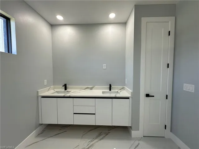 Bathroom featuring double vanity and tile patterned flooring