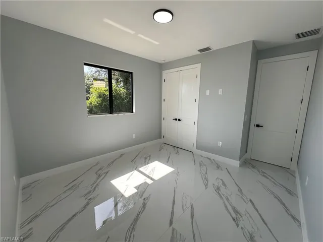 Unfurnished bedroom featuring light tile patterned flooring and a closet
