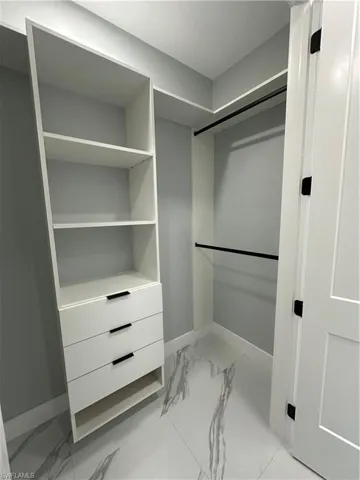Spacious closet featuring light tile patterned floors