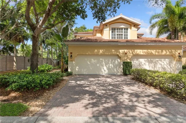 Mediterranean / spanish-style house featuring stucco siding, driveway, an attached garage, fence, and a tiled roof