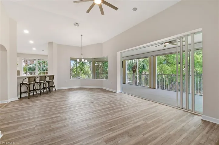 Unfurnished living room with ceiling fan, wood finished floors, baseboards, and recessed lighting