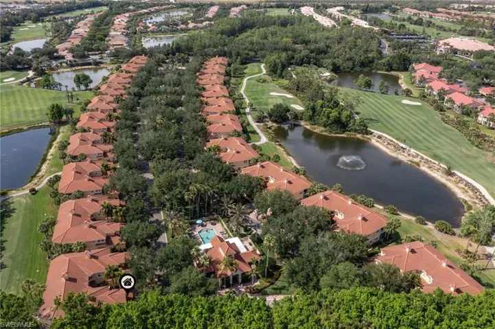 View of property location featuring nearby suburban area, a golf club, and a large body of water