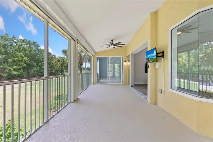 Unfurnished sunroom featuring ceiling fan and lofted ceiling