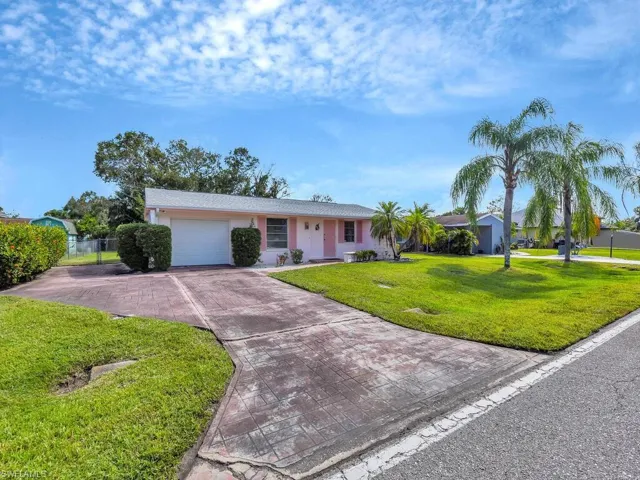 Single story home with a front lawn and a garage