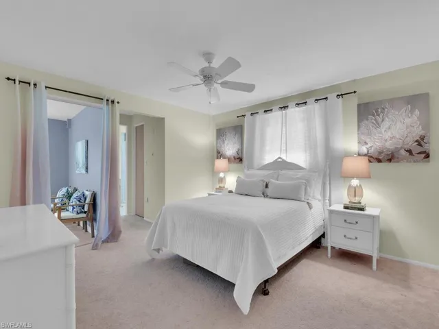 Bedroom with light colored carpet and ceiling fan