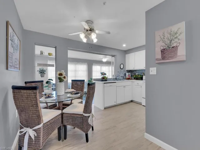 Dining space with sink, ceiling fan, and light hardwood / wood-style flooring