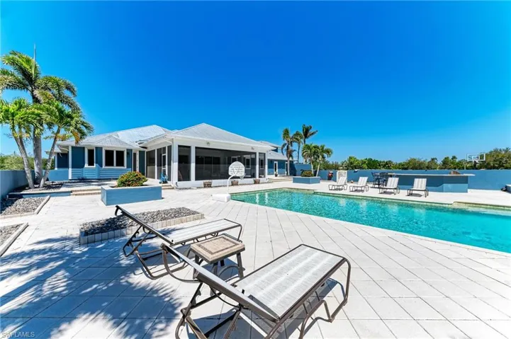 Community pool with a sunroom and a patio area
