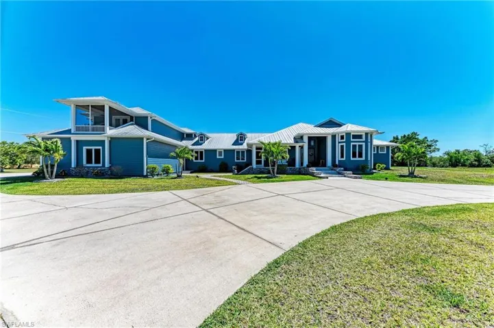 View of front of home with driveway and a front yard