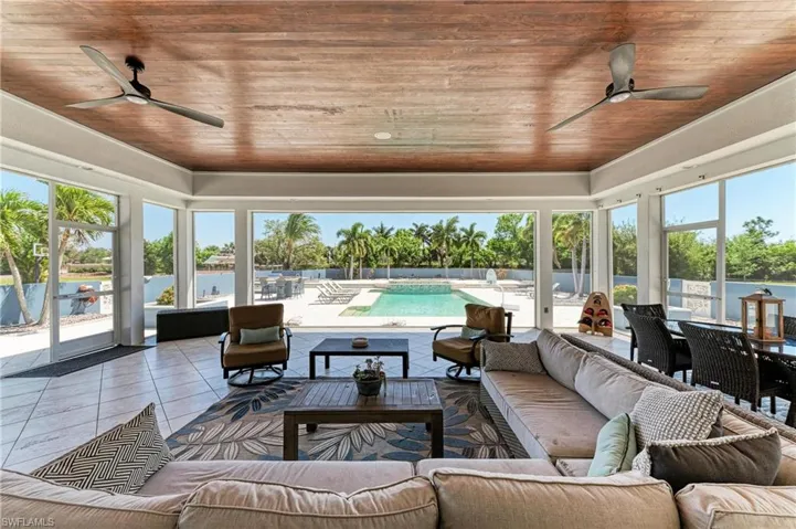 Sunroom featuring wooden ceiling and tile patterned flooring