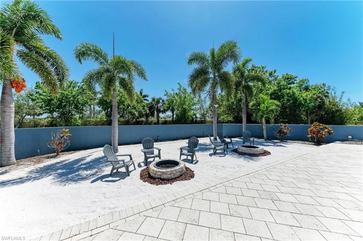 View of patio / terrace featuring an outdoor fire pit and fence