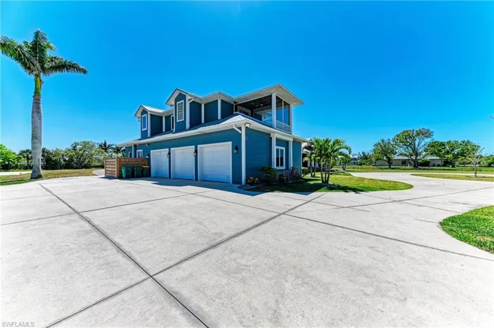 View of property exterior with concrete driveway and an attached garage