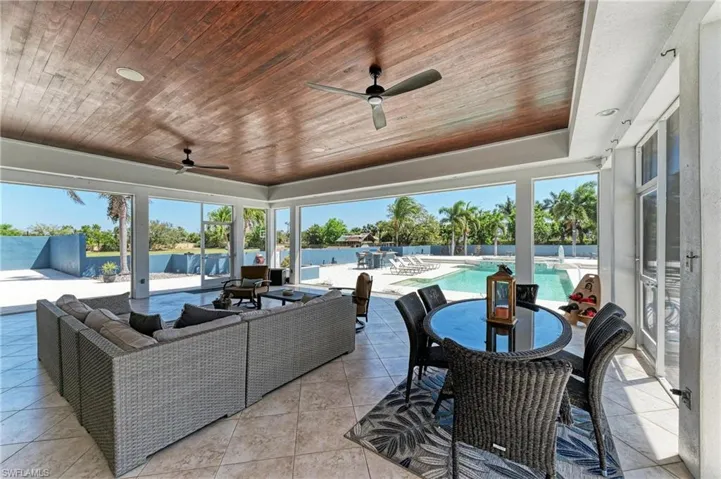 View of patio / terrace featuring outdoor lounge area, outdoor dining space, ceiling fan, and a fenced in pool
