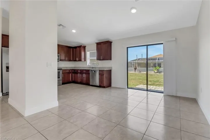 Kitchen featuring visible vents, baseboards, appliances with stainless steel finishes, and light tile patterned flooring