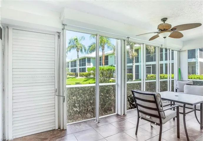 Screened lanai featuring tiled flooring and a ceiling fan