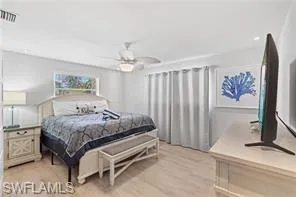 Bedroom with light wood-style floors, a ceiling fan, and recessed lighting