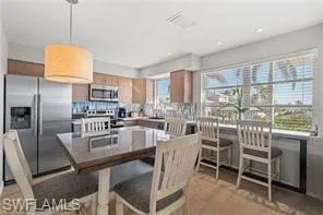 Dining room with light wood-style floors and recessed lighting