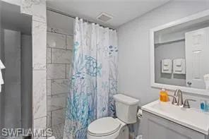 Bathroom with vanity and a shower stall