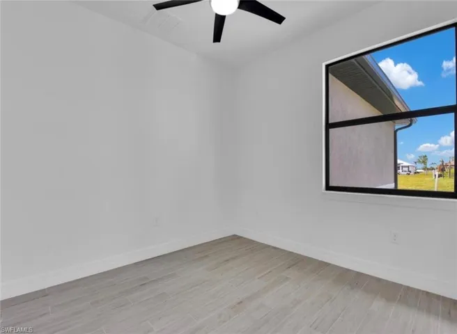 Spare room featuring light hardwood / wood-style floors and ceiling fan