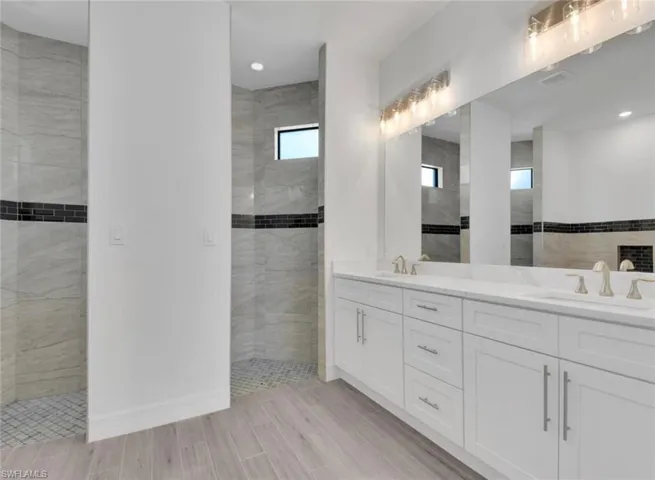 Bathroom with a tile shower and vanity