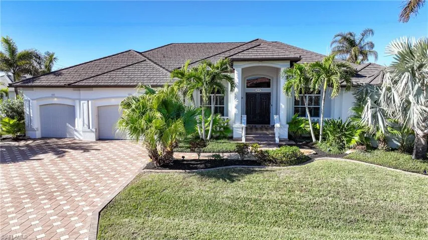 View of front facade with a garage and a front lawn