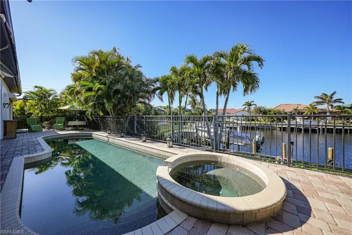 View of swimming pool featuring a patio and a water view