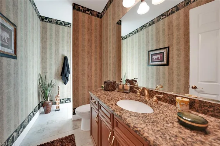Bathroom featuring tile patterned floors, vanity, and toilet