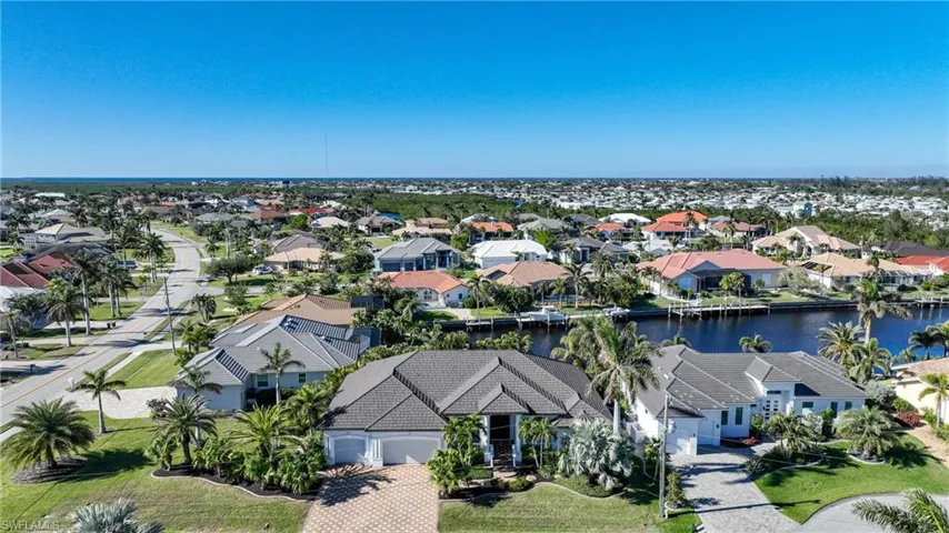 Birds eye view of property with a water view