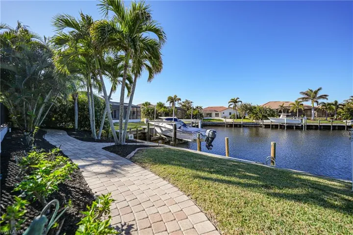 Dock area featuring a yard and a water view